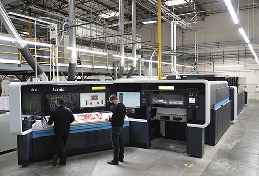 two workers using a landa digital printing machine